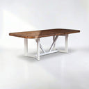 Wooden dining table with white metal base on a white background