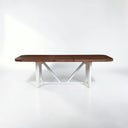 Wooden dining table with white base on a white background