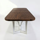 Wooden dining table with metal legs on a white background