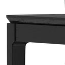 Close-up of a black wooden table corner on a white background